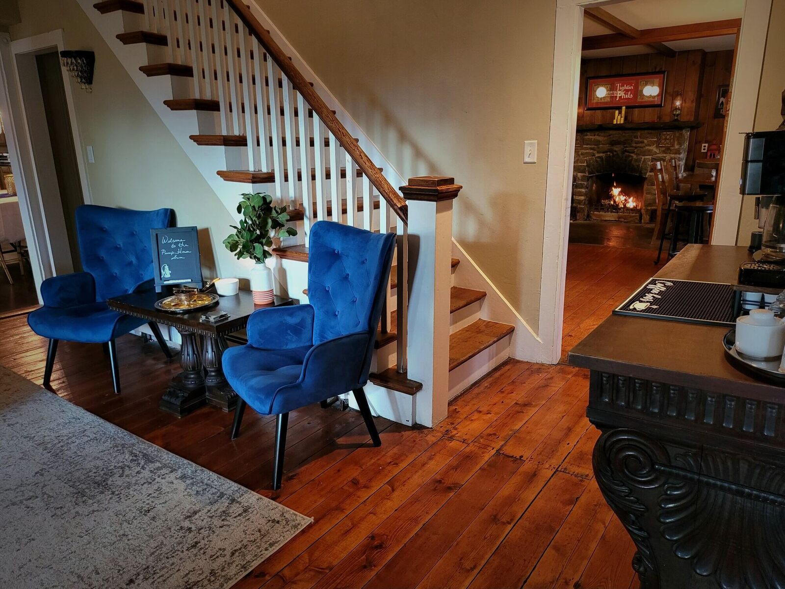 Two blue velvet chairs by the staircase at the Pump House.